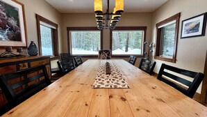 A dining room with a wooden table, chairs, and a chandelier. - The Great Escape at Heavens Gate A/C, fire pit, The Great Escape at Heavens Gate (McCall)