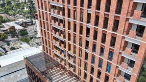 Un edificio moderno con piscina sul tetto e vista panoramica sui dintorni.