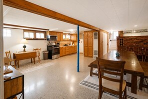A spacious kitchen with wooden cabinets, a microwave, and a stove.