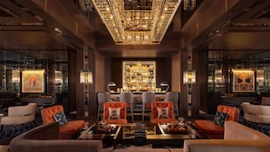 A luxurious lobby with a bar area, plush seating, and a decorative ceiling. - The Ritz-Carlton, Baku (Baku)
