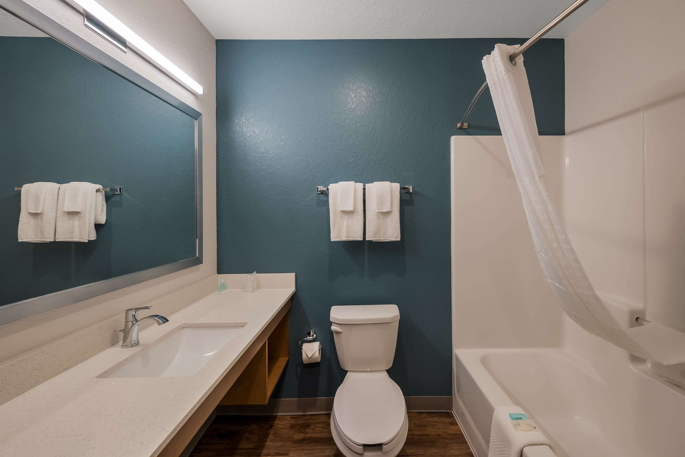 Un baño con lavamanos doble, inodoro y bañera.