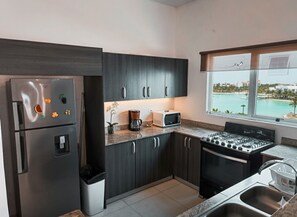 Fridge, microwave, stovetop, coffee/tea maker