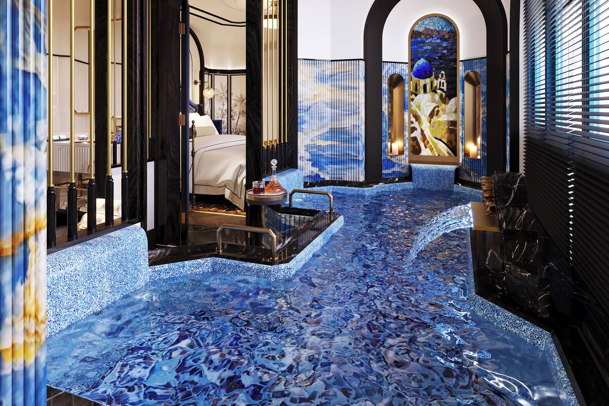 A luxurious hotel interior with a blue mosaic floor, a spacious bedroom, and a view of a mountain through a stained glass window.