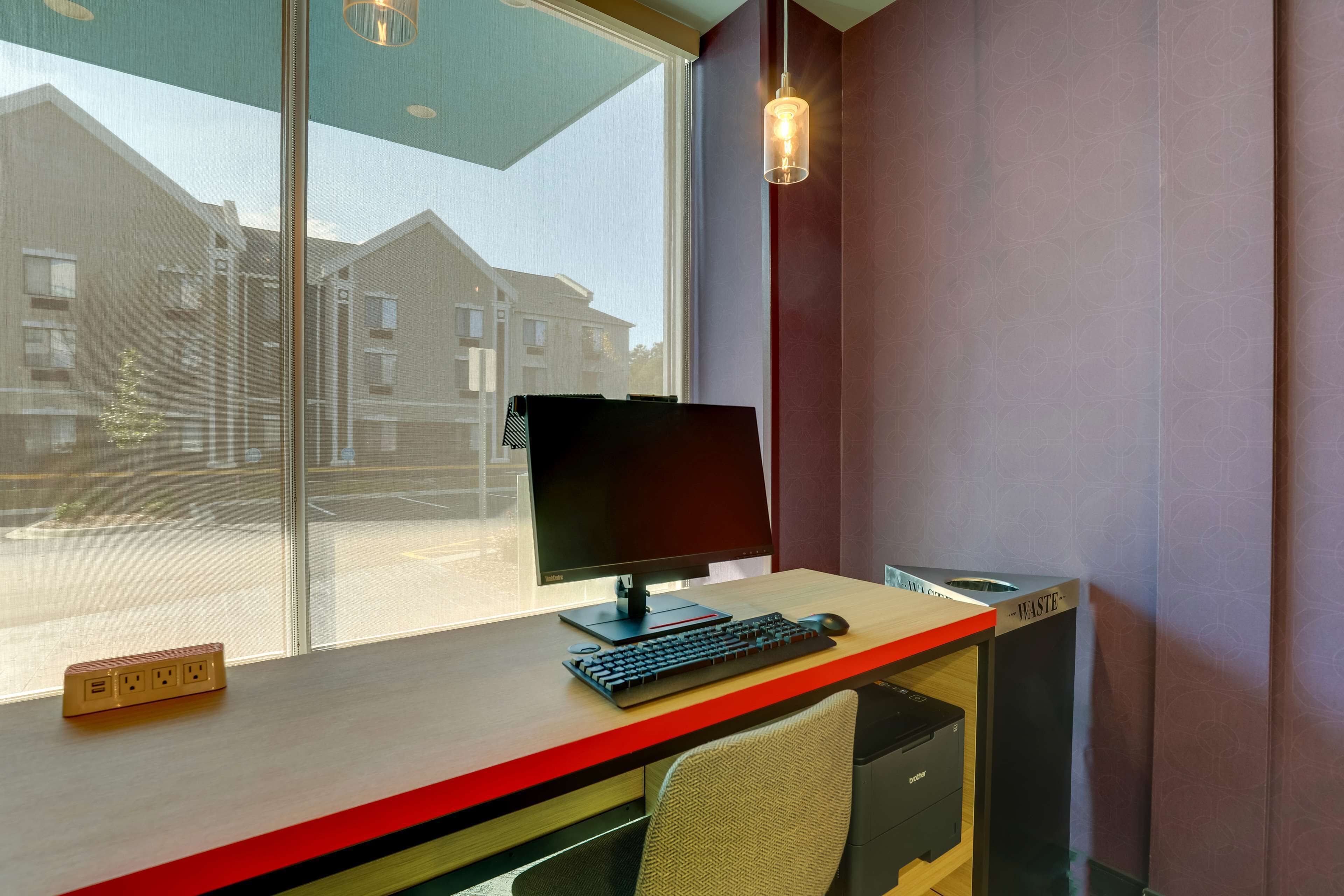 A modern office desk with a computer, keyboard, and mouse.