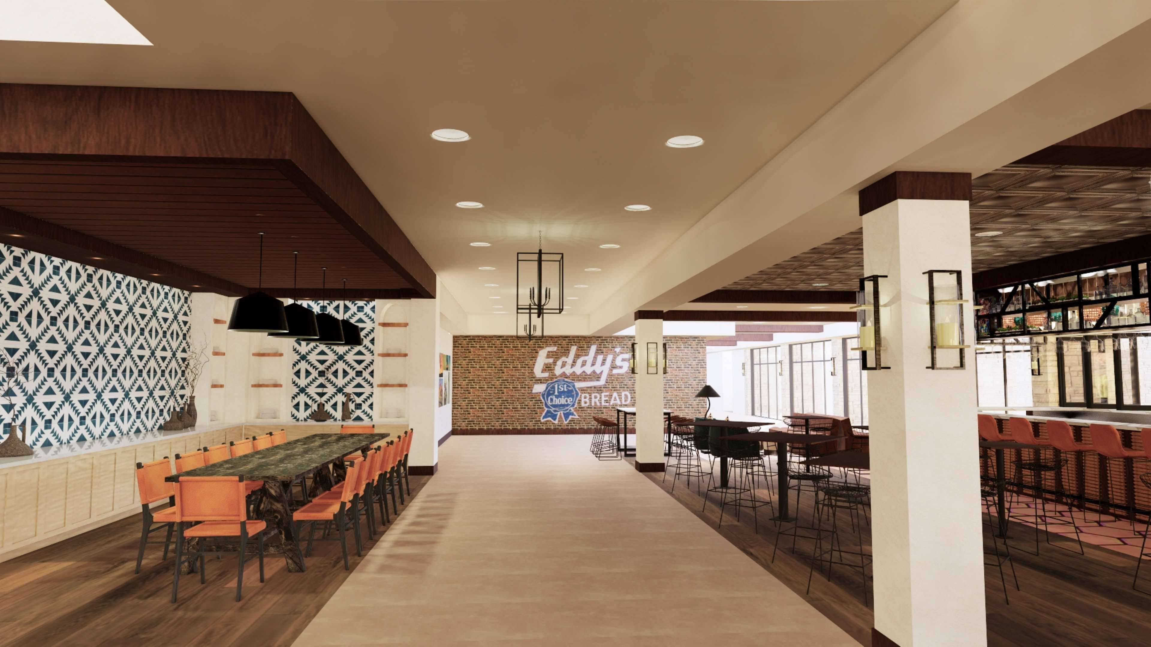 A spacious cafeteria with long tables and chairs, a brick wall with a '1st Choice Bread' sign, and a bar area with stools.