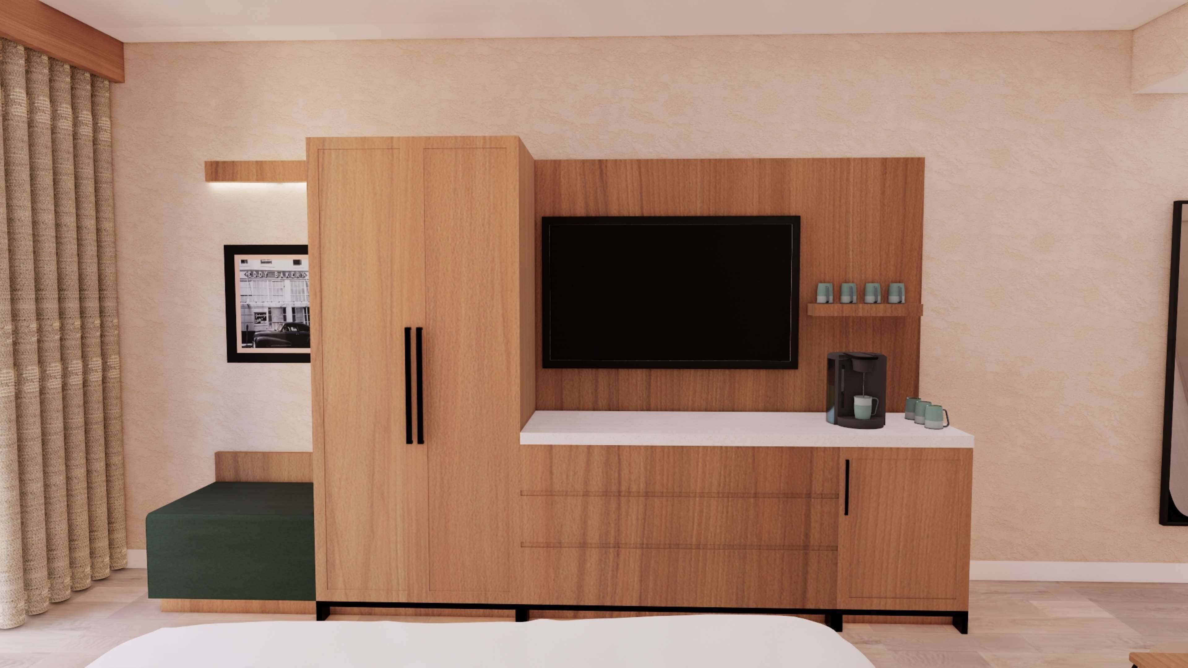 Un dormitorio moderno con un mueble bajo de madera para el televisor, un televisor de pantalla plana, una cafetera y un cuadro en la pared.
