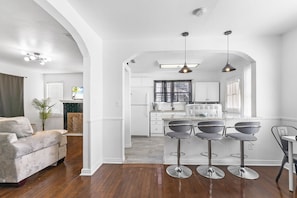 Relax in a spacious living area with a comfortable sofa, dining area, and bar setup.