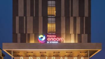 A modern hotel building with a prominent sign reading "Ramada Encore by Wyndham."