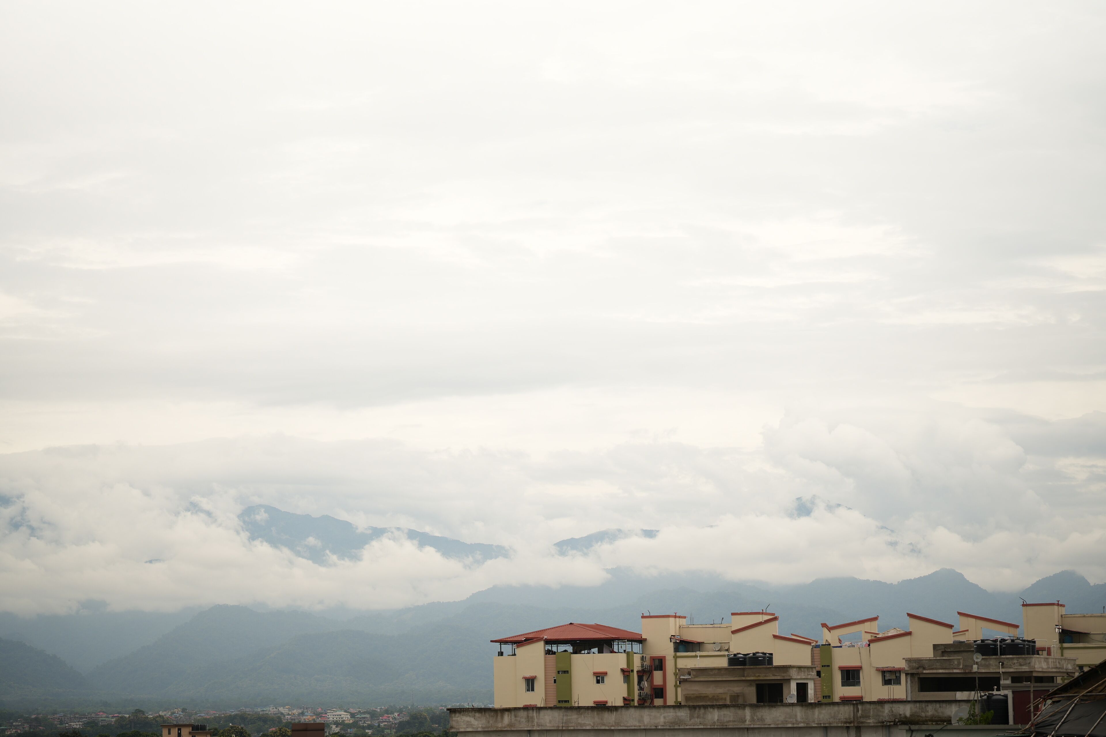 A row of buildings with a mountainous backdrop.