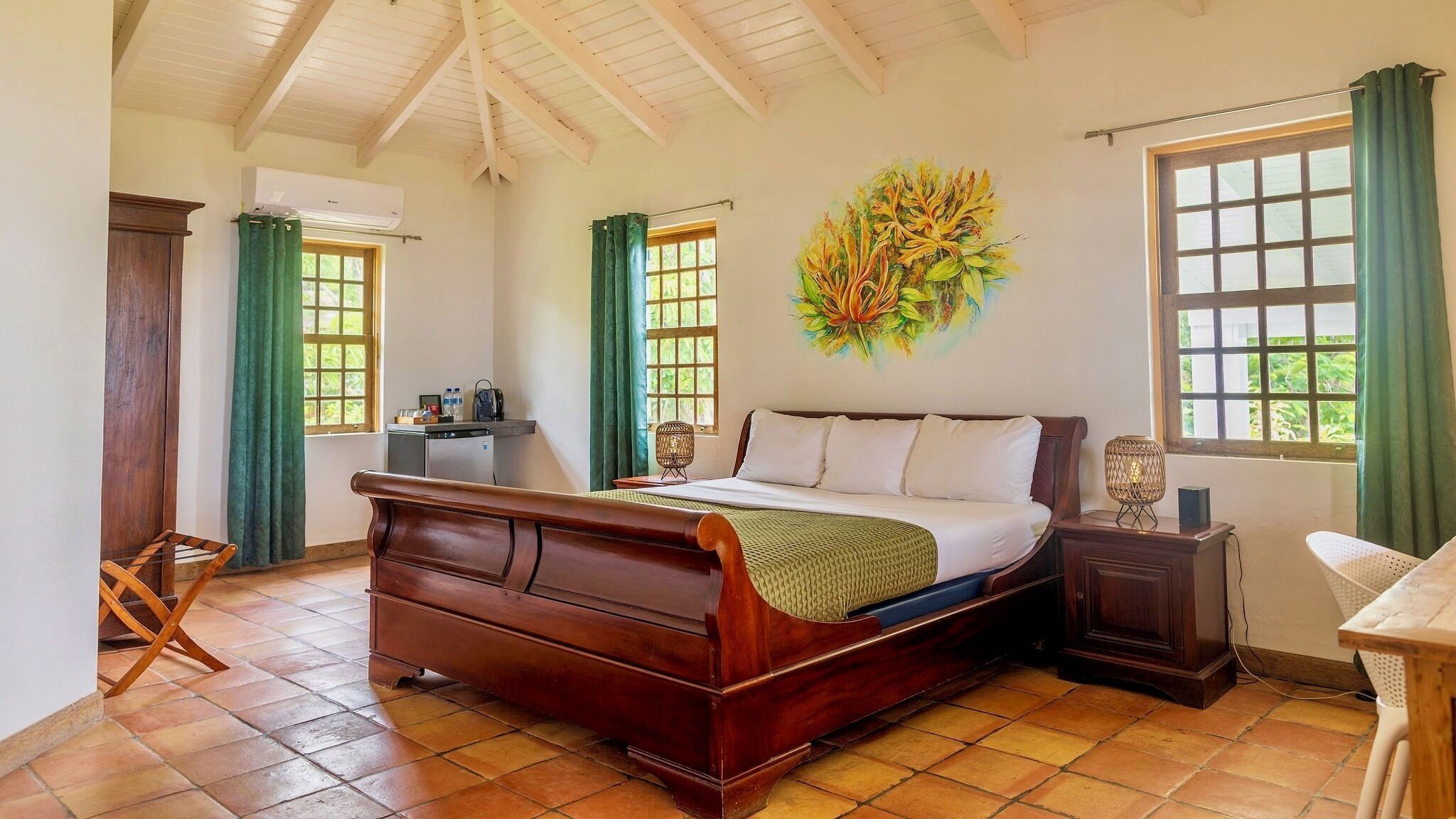 A bedroom with a wooden bed, a desk, a chair, and a wall-mounted air conditioner.