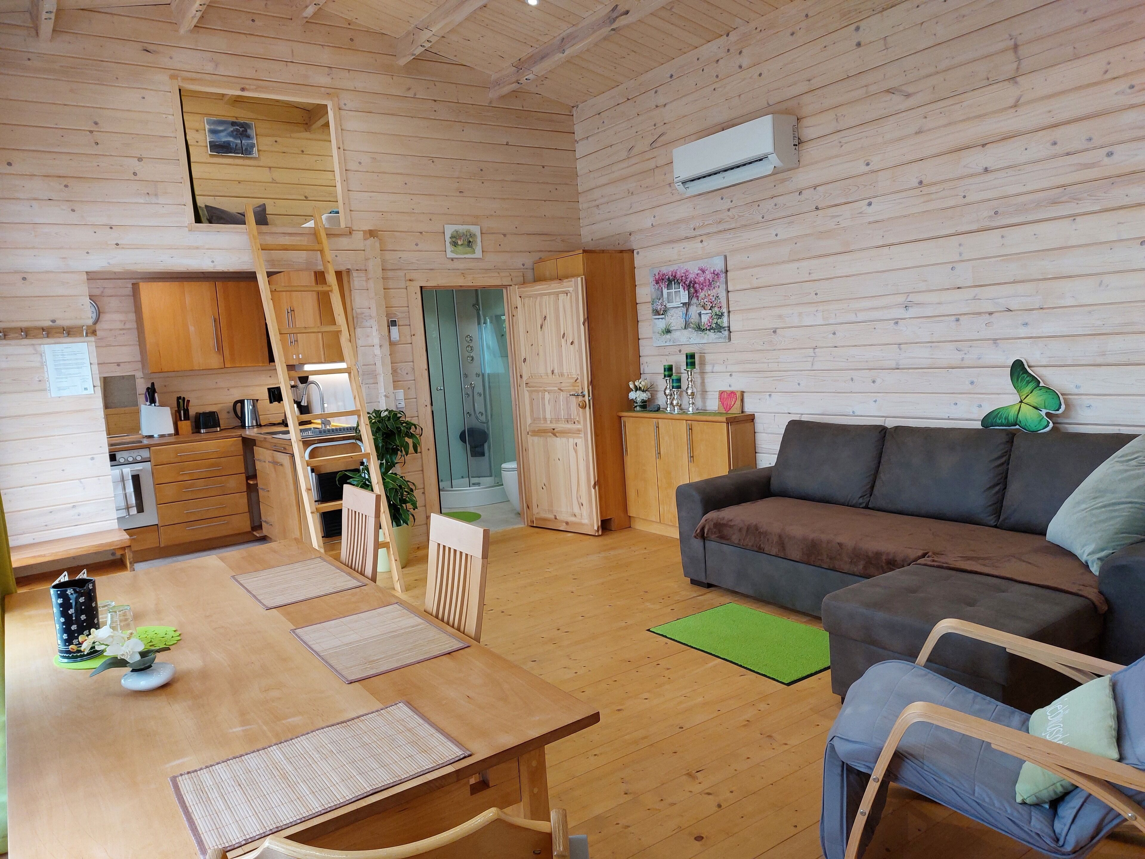 A wooden interior with a kitchen, dining area, and living room.