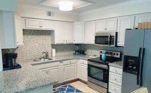 Enjoy cooking in this well-equipped kitchen with a microwave, gas stove, and refrigerator.