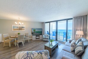 Relax in a spacious room with a sofa, armchairs, and ocean views.