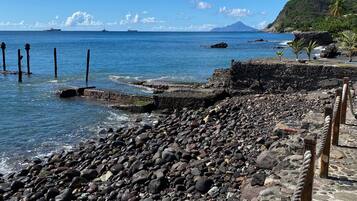 On the beach, black sand