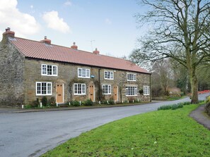 A stone house with a red-tiled roof, multiple windows, and a well-maintained garden. - Keldholme Cottage 1 - UK10992 (Keldholme, near Kirkbymoorside)