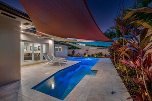 A modern outdoor pool area with two swimming pools, lounge chairs, and a covered seating area. - BY THE SEA VACATION VILLAS 4 BED PRIVATE POOL/STEPS TO BEACH gated community (Lauderdale-by-the-Sea)