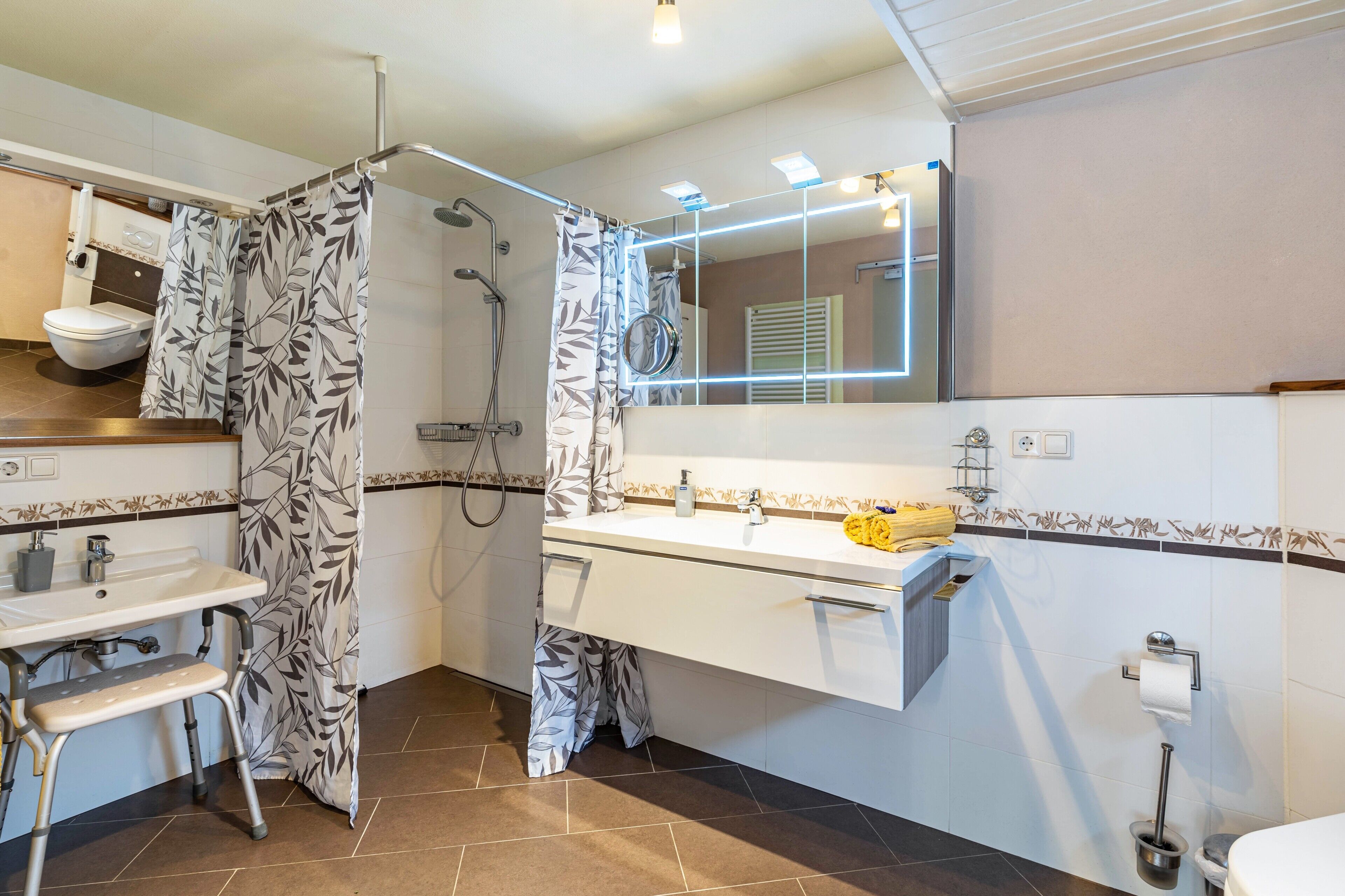 A bathroom with a shower, toilet, and sink.