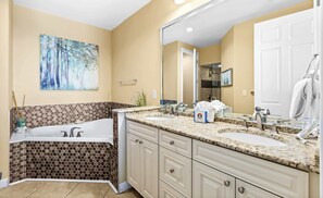 A bathroom with a double sink, a large mirror, and a painting on the wall. - The Crescent 412 (Miramar Beach)