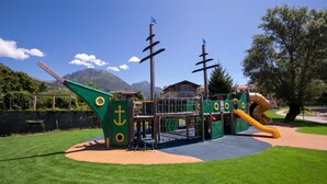 A playground with a slide and climbing structures. - Porto Letizia T11, Porlezza, Italy (Porlezza)