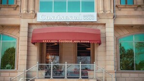 The exterior of the Continental Hotel with a red awning and a sign indicating it is a 4-star hotel. - Continental Hotel Baku (Baku)