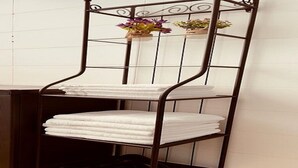 A metal shelf with white towels stacked on it. - Apartment on the beach, new (Bat Yam)