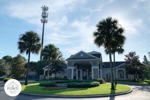 A two-story building with a central entrance, surrounded by well-maintained landscaping and palm trees. - 3176-301 Resort 2BR Apt by Disney World Orlando (Kissimmee)