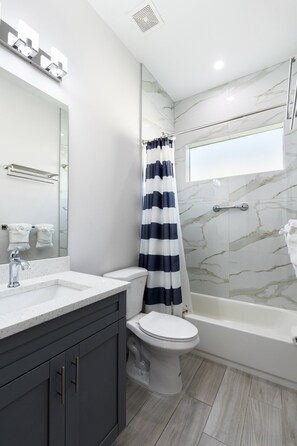 Combined shower/tub, hair dryer, towels, soap