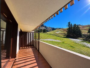 A balcony with a view of a mountainous landscape.