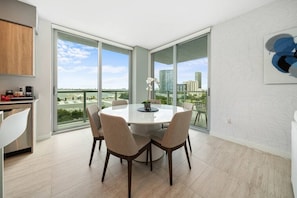Enjoy meals with friends and family at the large dining table, surrounded by six chairs.