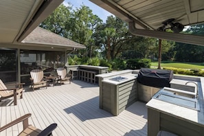 An outdoor deck with a barbecue area, seating, and a sink. - Luxury Hilton Head Home, Golf Course View, w/ Pool (Hilton Head Island)