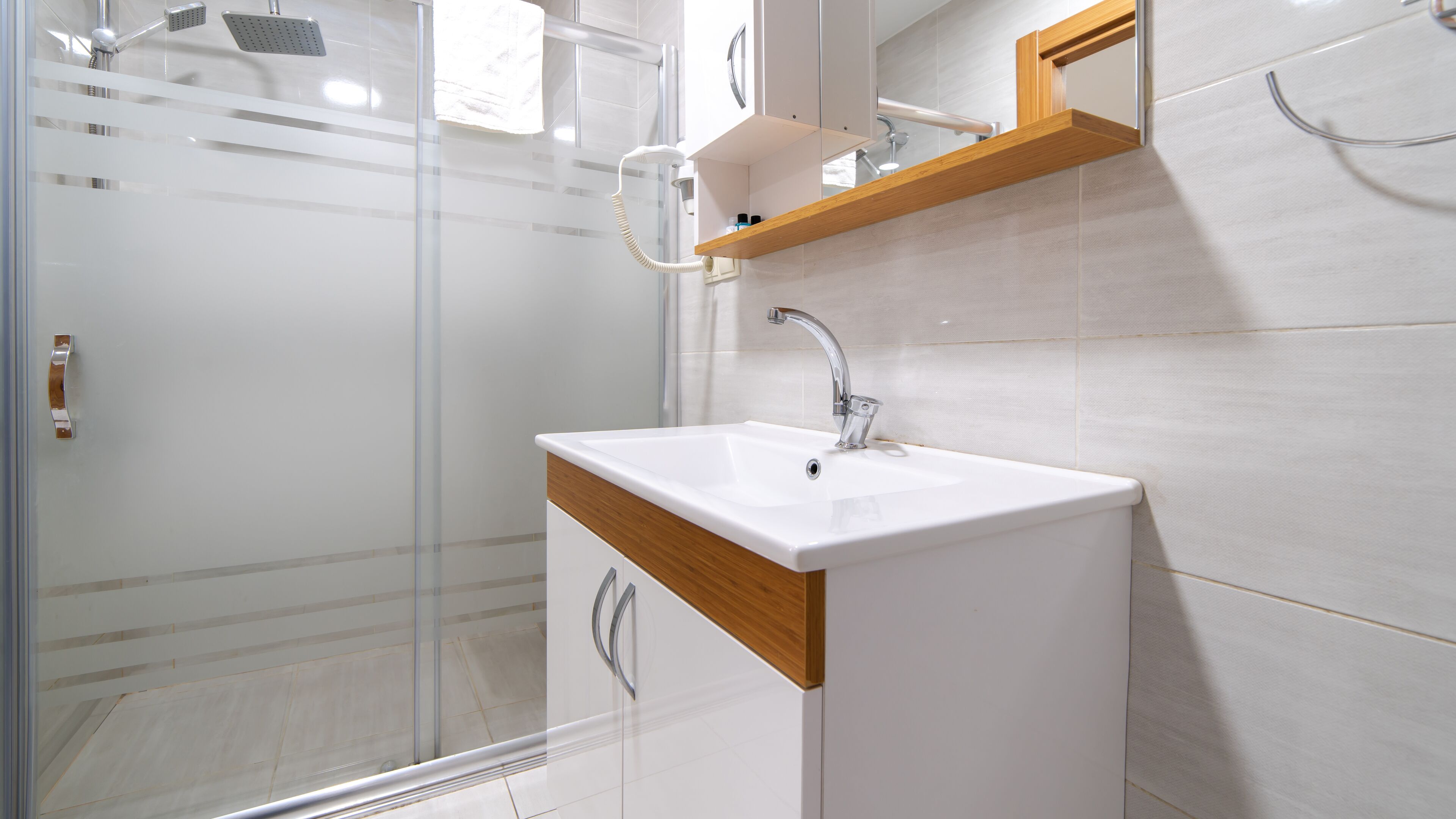 deluxe studio suite | bathroom | shower, rainfall showerhead, hair dryer, heated floors