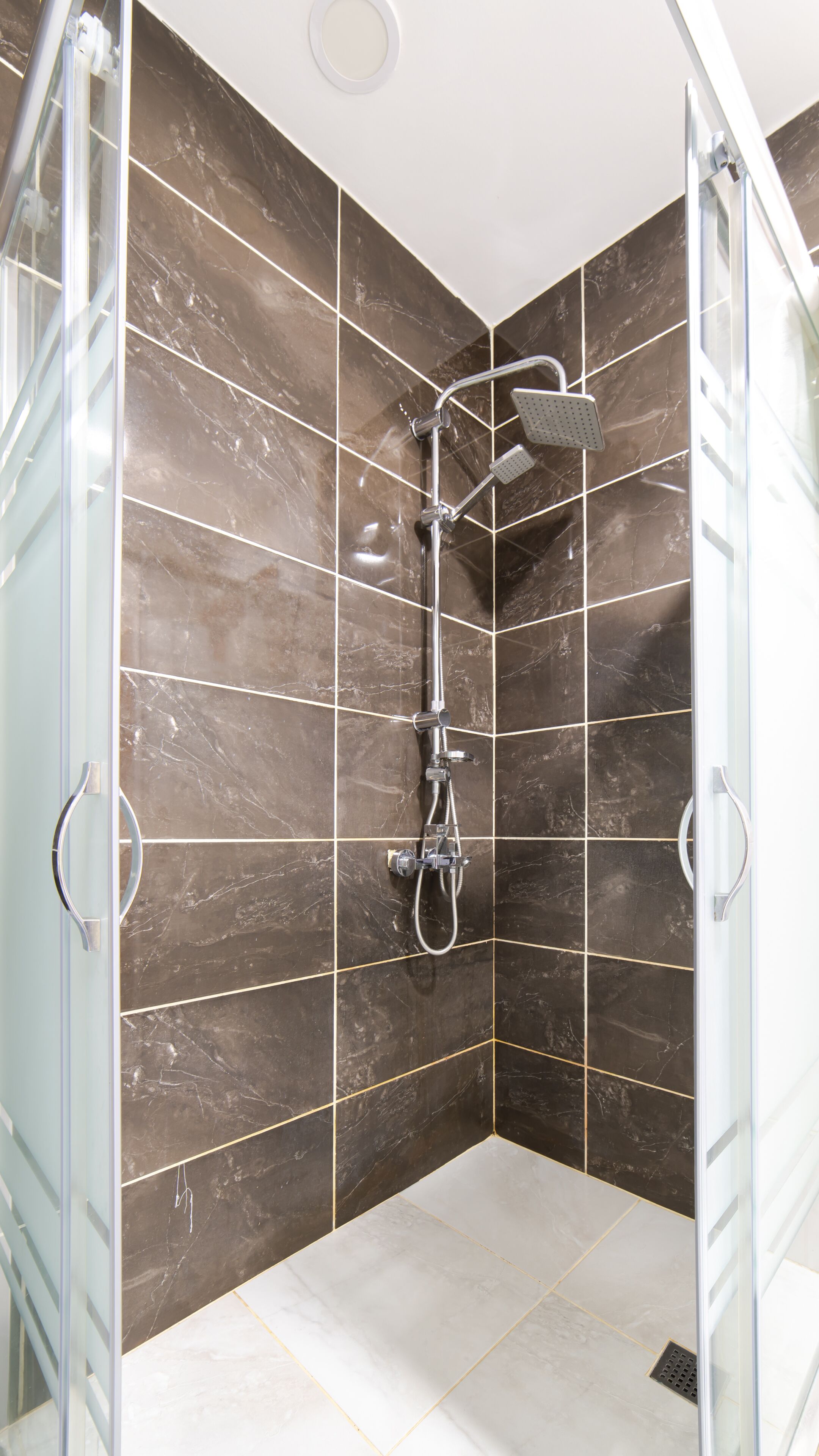 standard studio | bathroom | shower, rainfall showerhead, hair dryer, heated floors