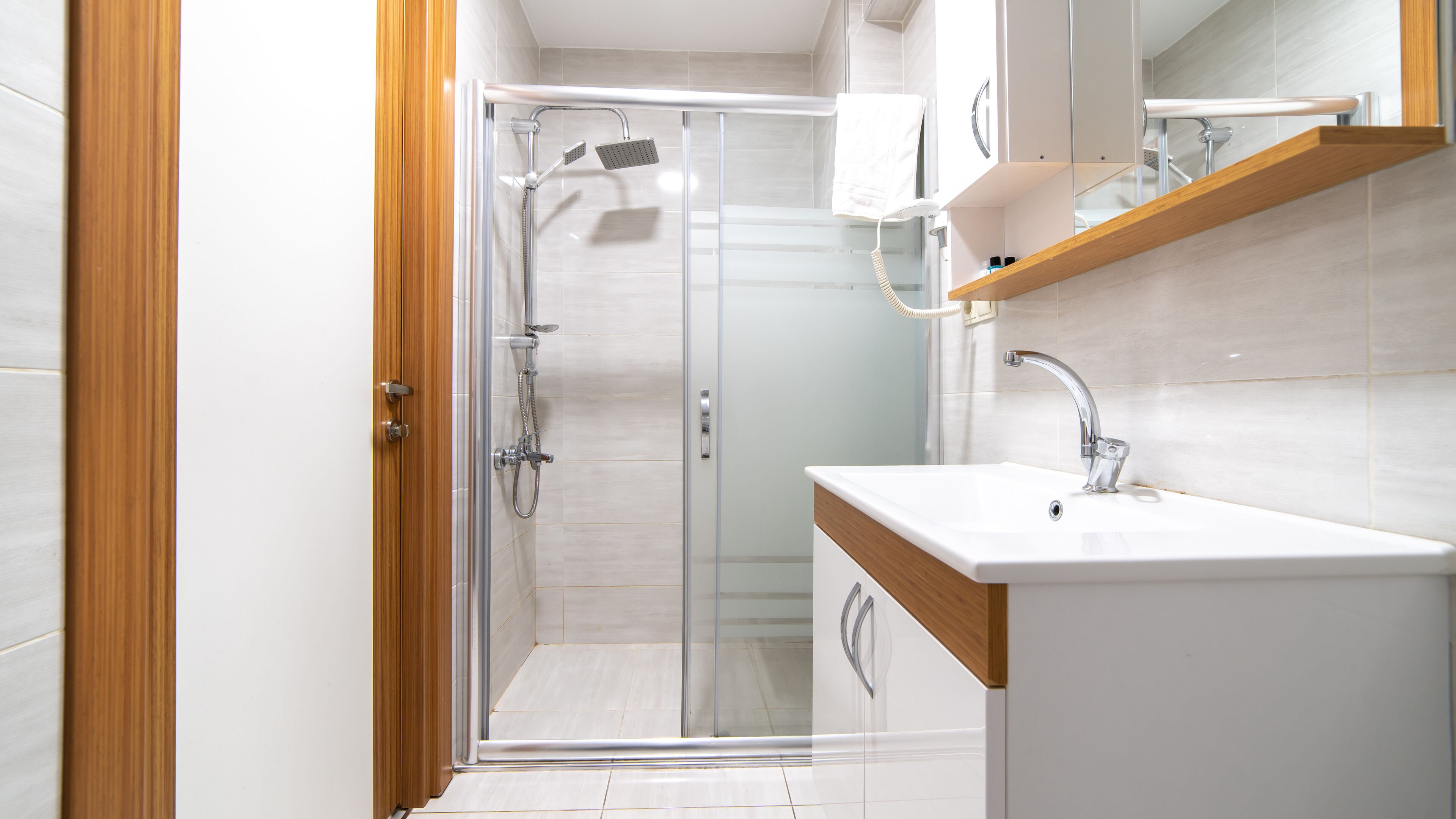 deluxe studio suite | bathroom | shower, rainfall showerhead, hair dryer, heated floors