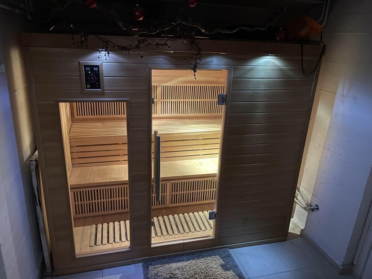 A wooden sliding door with a control panel above it.