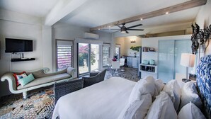 A hotel room with a large bed, a sofa, a dining area, and a kitchen. - STARLIGHT: GORGEOUS VIEWS OF THE BEACH, FORT BERKLEY & MONTSERRAT (English Harbour)
