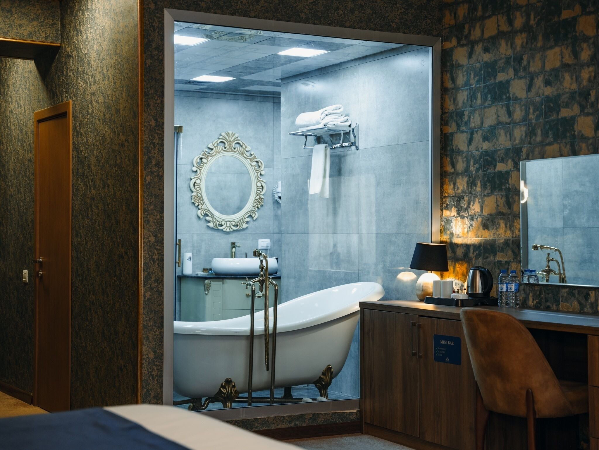 A bathroom with a freestanding bathtub, a vanity with a mirror, and a shower area.
