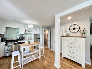 Enjoy cooking in this well-lit kitchen with a central island, sink, and stainless steel appliances.