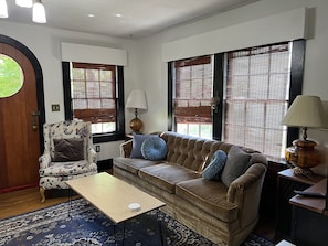 Relax in this inviting living room with a sofa, armchair, and coffee table.