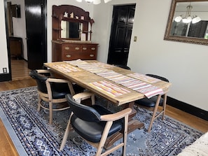 Enjoy meals with friends and family at this dining area, featuring a long table and six comfortable chairs.