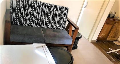 Modern studio decorated in African colors at the rear of a spacious villa.