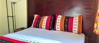 Modern studio decorated in African colors at the rear of a spacious villa.