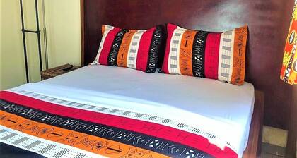 Modern studio decorated in African colors at the rear of a spacious villa.