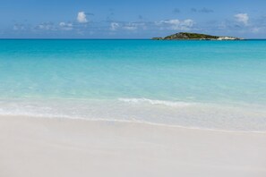 A beach with clear turquoise water and a small island in the distance. - Sunset Villa - Exuma Bahamas with Private Heated Pool!, Vacation Villa Moments with Private Heated P... (Moore Hill)