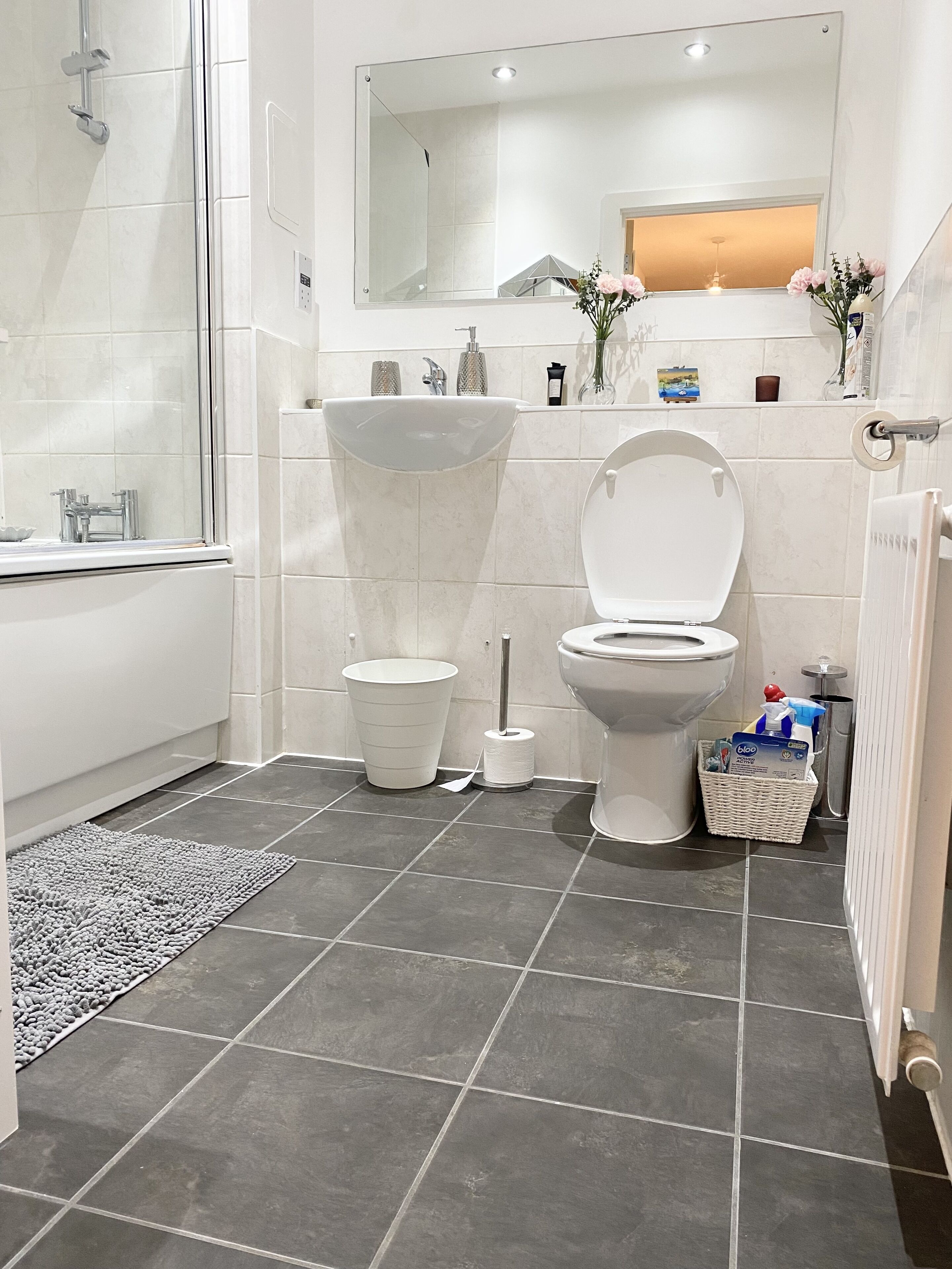 A modern bathroom with a bathtub, toilet, and sink.