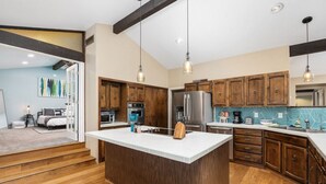 A modern kitchen with wooden cabinets, a large island, stainless steel appliances, and pendant lighting. - Mtn View, Hot Tub, Open Kitchen, 10m to Sequoia (Three Rivers)