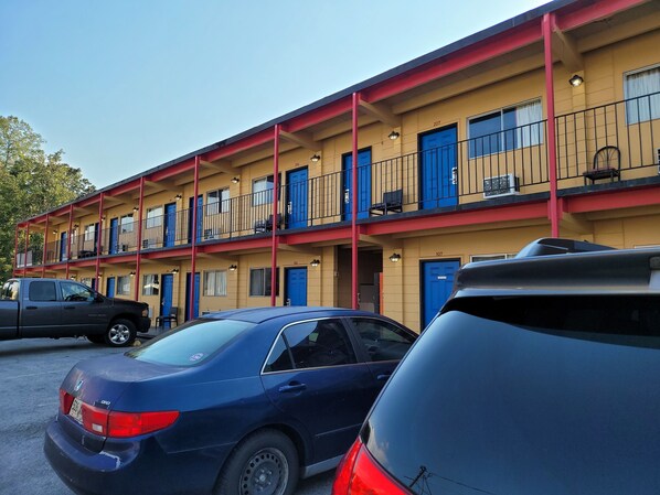 A motel with multiple floors, each with blue doors and balconies.