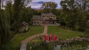 A large house with a spacious backyard, a swimming pool, and a pond with lily pads. - Exceptional Getaway for Family & Friends (Rush City)