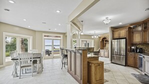 A spacious kitchen with a central island, large windows, and a view of the outdoors. - Exceptional Getaway for Family & Friends (Rush City)