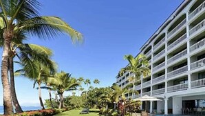 A hotel with multiple balconies, a pool area, and palm trees. - Legal STR Hotel Zoned Lahaina Shores Serene Beachfront Escape with Mountain View (Lahaina)