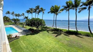 A pool with a view of the ocean and palm trees. - Legal STR Hotel Zoned Lahaina Shores Serene Beachfront Escape with Mountain View (Lahaina)